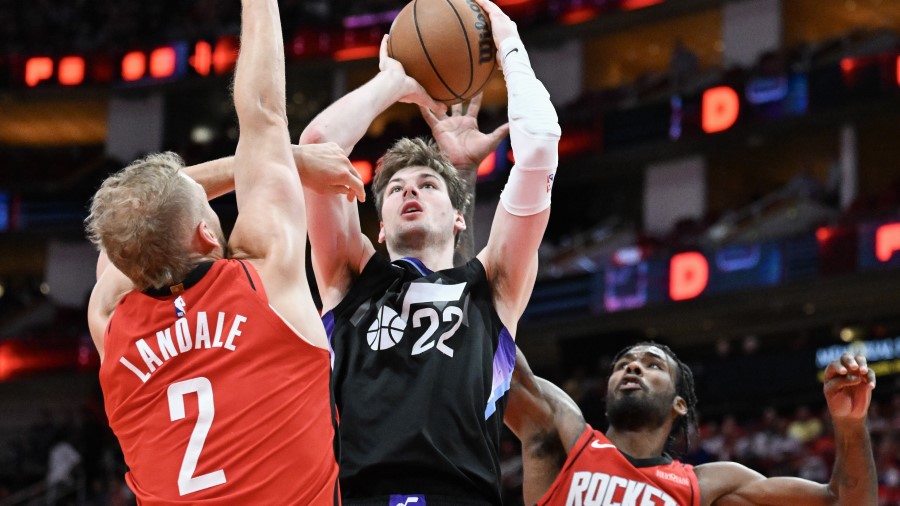 Tari Eason #17 of the Houston Rockets blocks a shot by Kyle Filipowski #22 of the Utah Jazz as Jock...