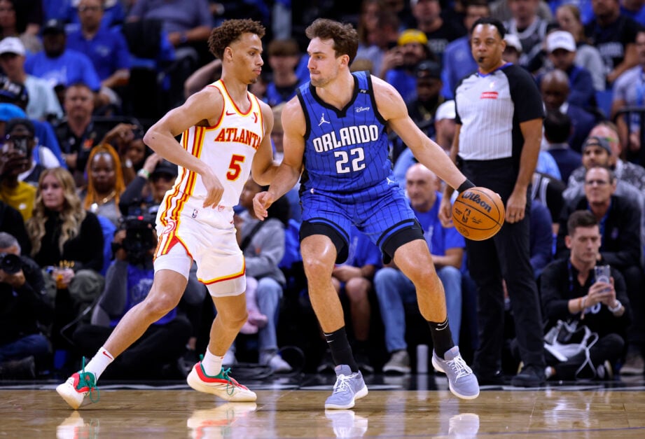 Franz Wagner #22 of the Orlando Magic posts up Dyson Daniels #5 of the Atlanta Hawks during the first half of an NBA play-in tournament game at Kia Center on April 15, 2025