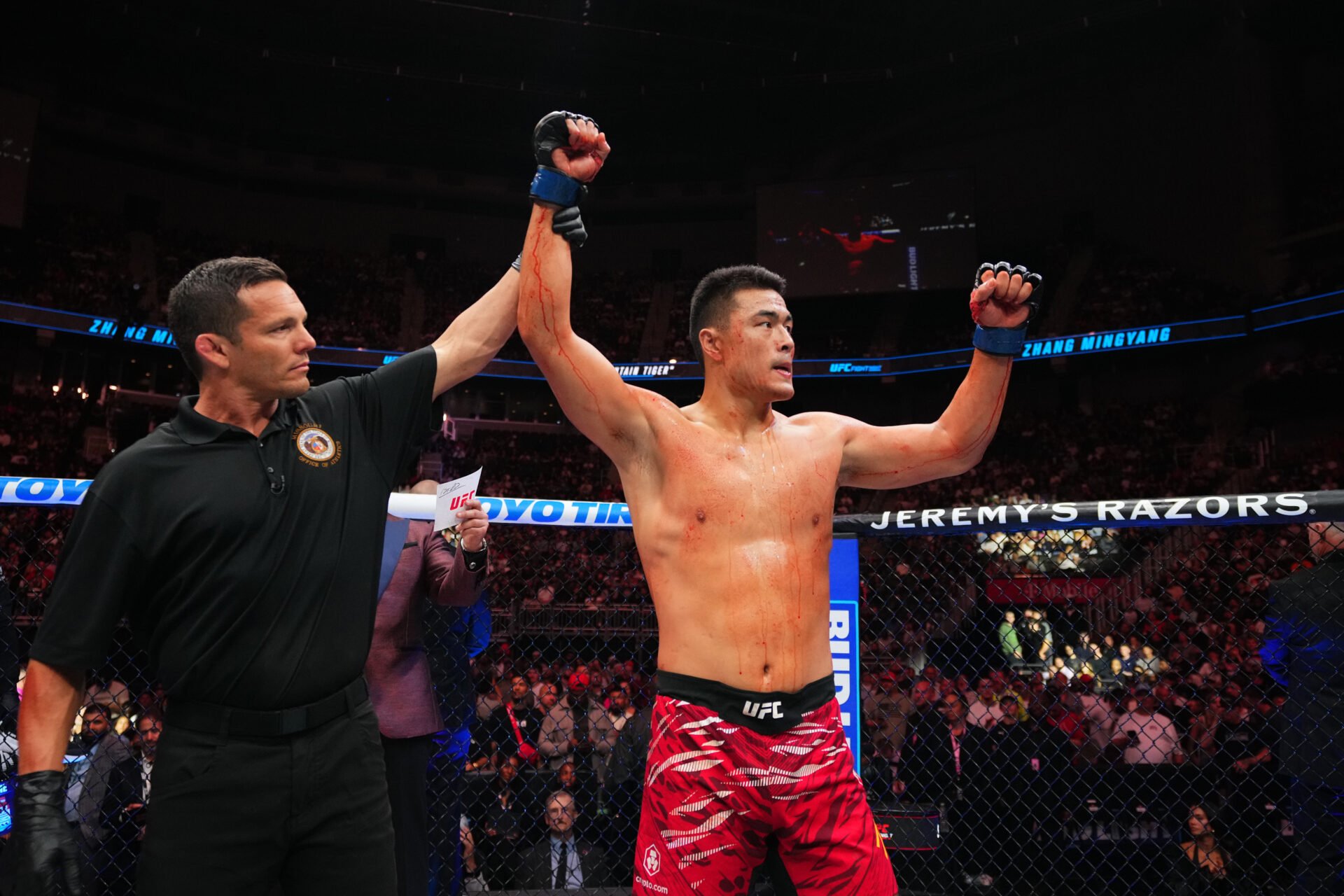 Zhang Mingyang celebrates his win over Anthony Smith