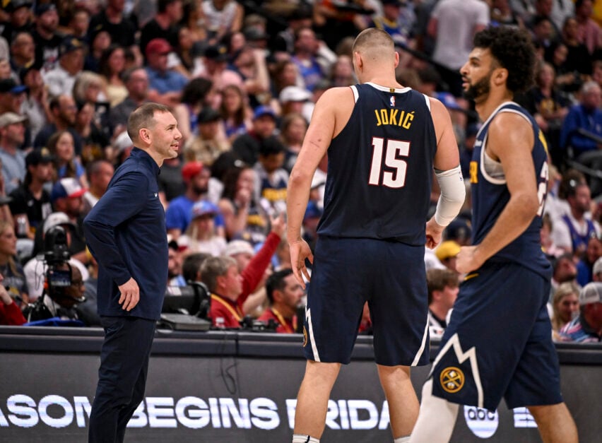 Head coach David Adelman of the Denver Nuggets speaks to Nikola Jokic (15) as Jamal Murray (27) stands on the court during the second quarter against the Oklahoma City Thunder at Ball Arena in Denver, Colorado on Sunday, May 11, 2025.