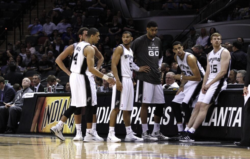 Tim Duncan #21 (center) stands with Marco Belinelli #3, Danny Green #4, Cory Joseph #5 Austin Daye #23 and Matt Bonner #15 of the San Antonio Spurs in the closing minutes against the Dallas Mavericks in Game Two of the Western Conference Quarterfinals during the 2014 NBA Playoffs