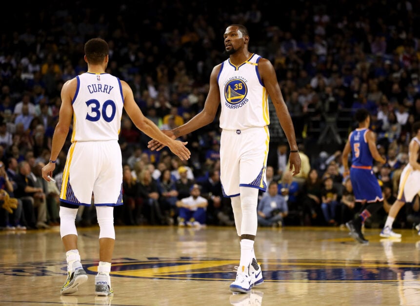 Kevin Durant #35 and Stephen Curry #30 of the Golden State Warriors high-five one another during their game against the New York Knicks.