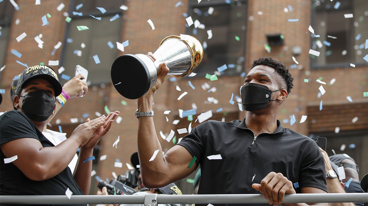 Milwaukee Bucks forward Giannis Antetokounmpo (34) holds his NBA Finals MVP Trophy during the Milwaukee Bucks victory parade.