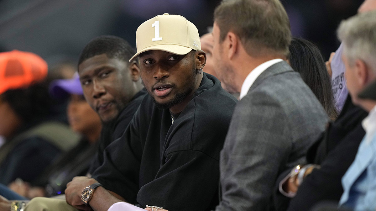 Golden State Warriors forward Jonathan Kuminga (center left) talks with owner Joe Lacob (center right) during the second quarter of the game between the Golden State Valkyries and the Los Angeles Sparks at Chase Center.