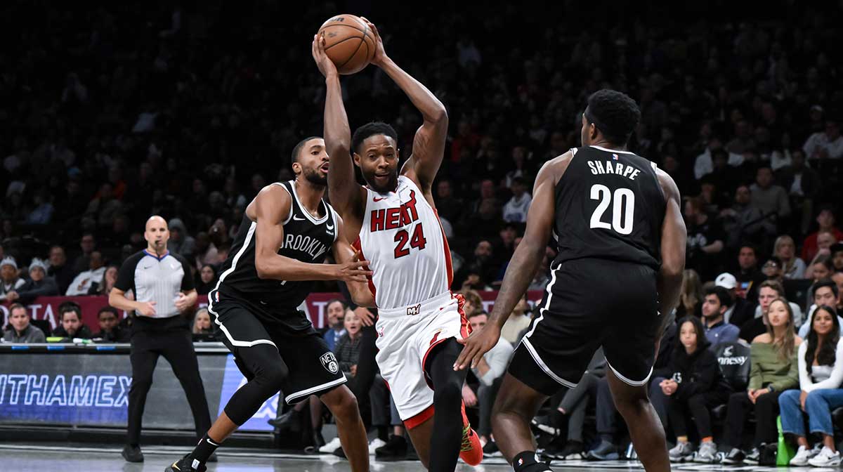 Miami Heat forward Haywood Highsmith (24) drives against Brooklyn Nets forward Mikal Bridges (1) and center Day'Ron Sharpe (20) during the second quarter at Barclays Center.