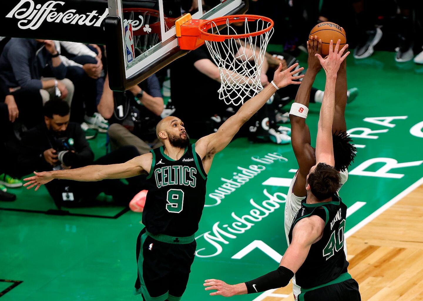 Boston Celtics guard Derrick White (No. 9) blocked a shot by New York Knicks forward OG Anunoby (No. 8) during an NBA Eastern Conference semifinal against the New York Knicks at TD Garden in May.