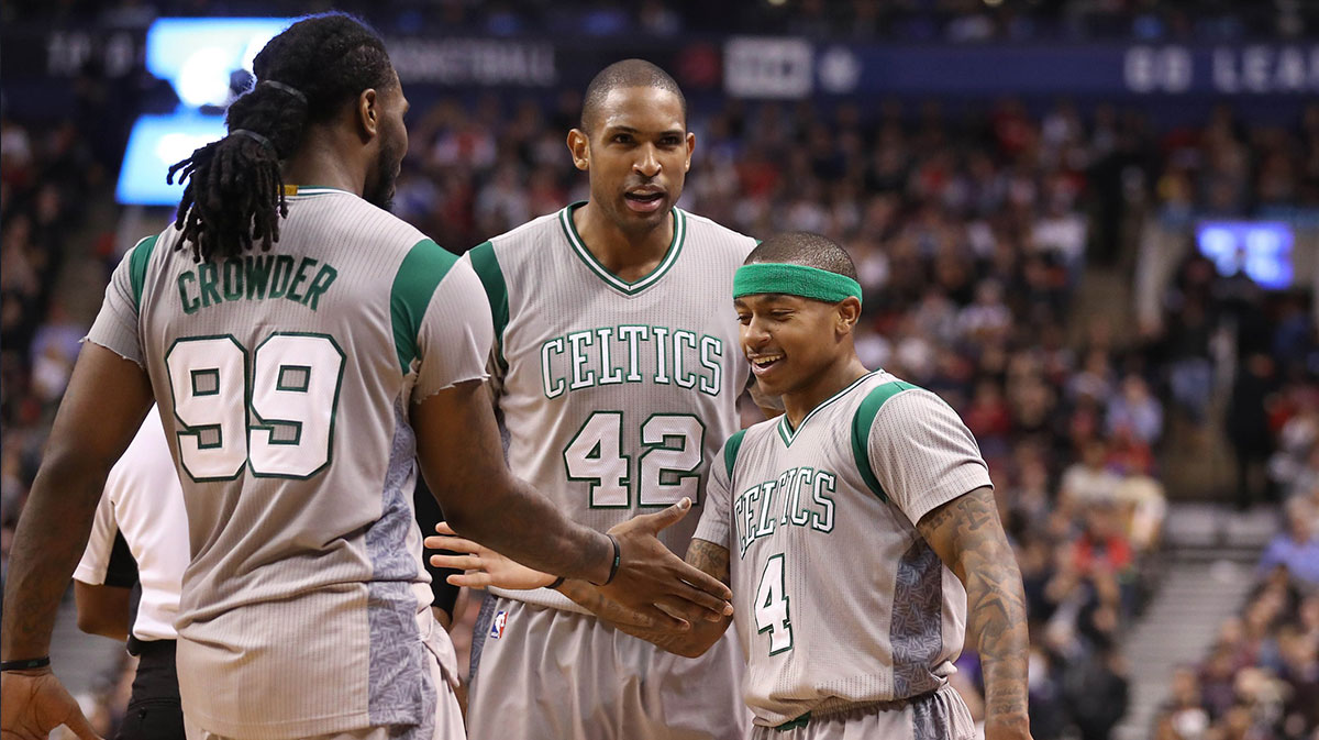 Boston Celtics point guard Isaiah Thomas (4) is congratulated by forward Jae Crowder (99) and forward Al Horford (42) against the Toronto Raptors at Air Canada Centre. The Raptors beat the Celtics 114-106.