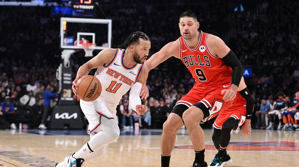New York Knicks guard Jalen Brunson (11) drives to the basket while being defended by Chicago Bulls center Nikola Vucevic (9) during the first half at Madison Square Garden.