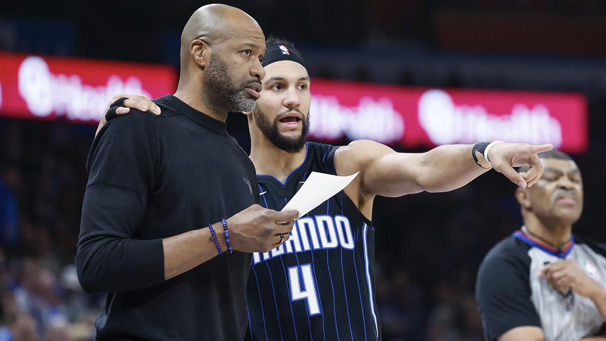 Orlando Magic guard Jalen Suggs (4) talks to head coach Jamahl Mosley during the second quarter at Paycom Center.