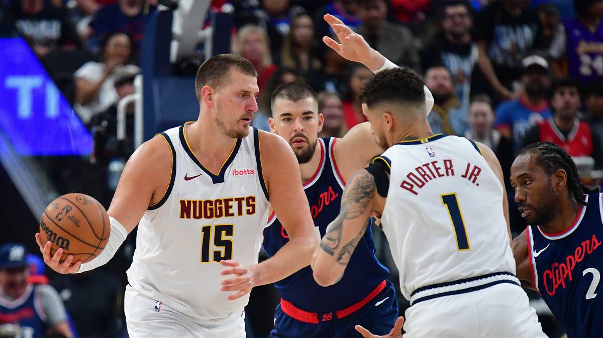 Denver Nuggets center Nikola Jokic (15) passes the ball to forward Michael Porter Jr. (1) against Los Angeles Clippers center Ivica Zubac (40) during the second half of game three in the first round for the 2024 NBA Playoffs at Intuit Dome.