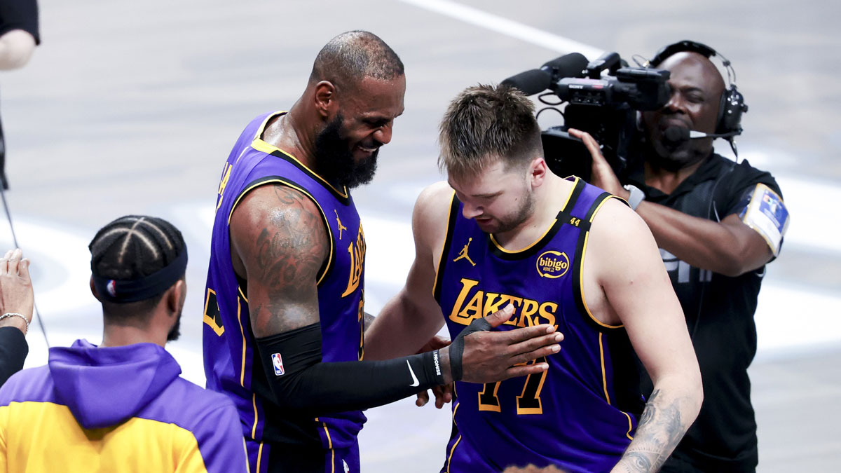 Lakers forward LeBron James (23) celebrates with Los Angeles Lakers guard Luka Doncic (77) during the fourth quarter against the Dallas Mavericks at American Airlines Center