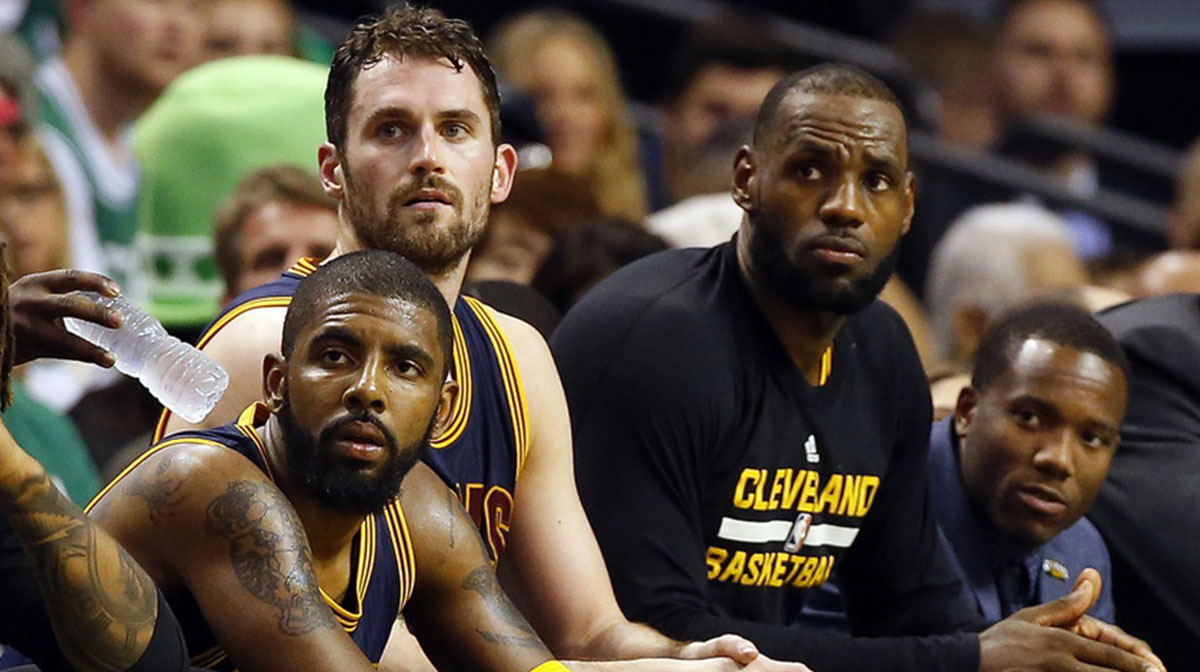 Cleveland Cavaliers guard Kyrie Irving (left), forward Kevin Love (center) and forward LeBron James (right) look on from the bench during the second half against the Boston Celtics in game two of the Eastern conference finals of the NBA Playoffs at TD Garden.