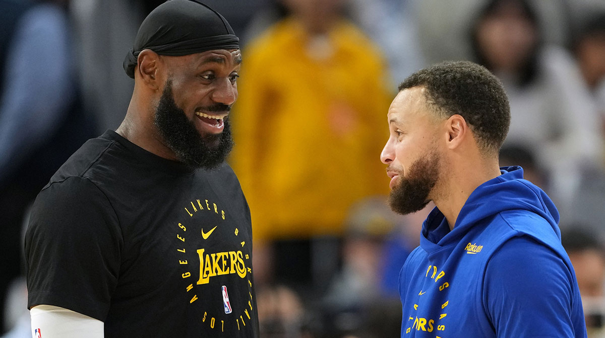 Los Angeles Lakers forward LeBron James (left) and Golden State Warriors guard Stephen Curry (right) talk before the game at Chase Center.