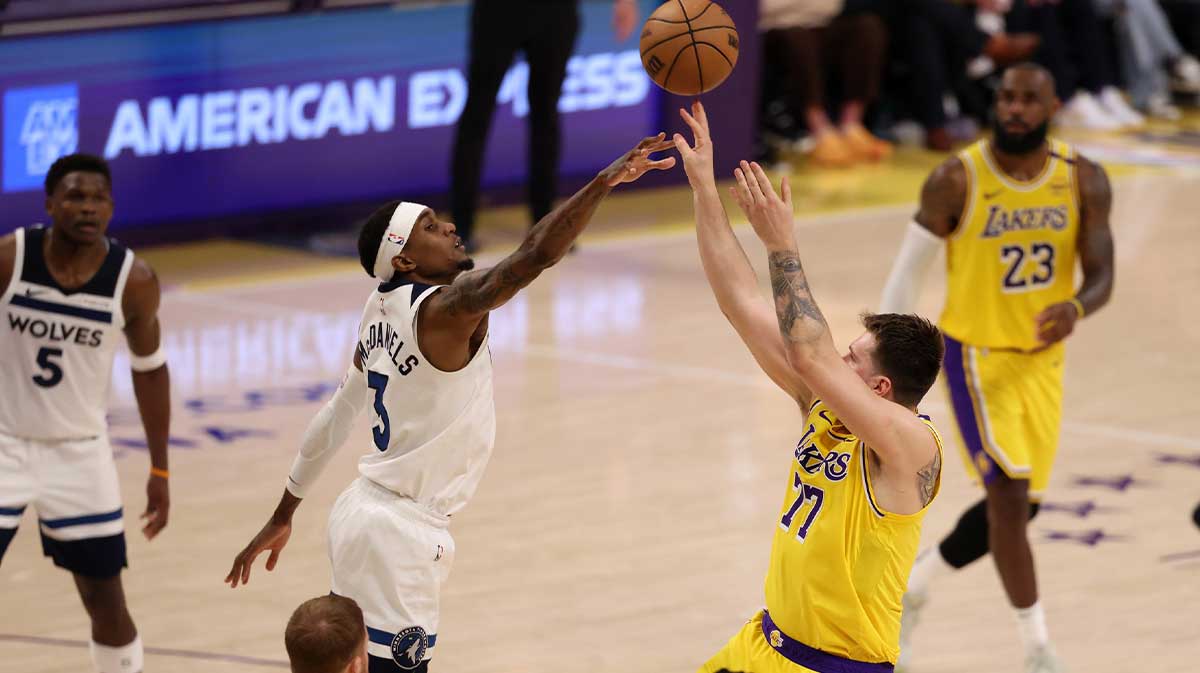 Los Angeles Lakers guard Luka Doncic (77) shoots the ball over Minnesota Timberwolves forward Jaden McDaniels (3) during the third quarter of game two of first round for the 2024 NBA Playoffs at Crypto.com Arena.