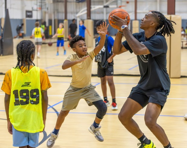 Brooklyn Nets star Terance Mann, right, shared the court with a young camper during his Complete Player Foundation event Wednesday at The Mill Works in Westford. (James Thomas for the Lowell Sun)