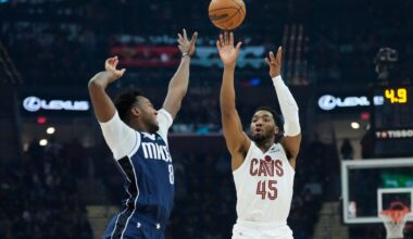 Cleveland Cavaliers guard Donovan Mitchell (45) shoots a 3-point basket over Dallas Mavericks forward Olivier-Maxence Prosper (8) in the first half of an NBA basketball game, Sunday, Feb. 2, 2025, in Cleveland. (AP Photo/Sue Ogrocki)