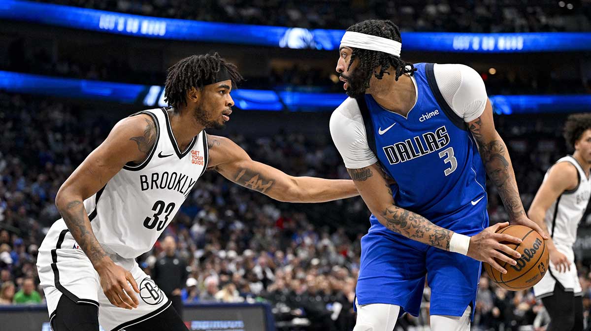 Dallas Mavericks forward Anthony Davis (3) looks to move the ball past Brooklyn Nets center Nic Claxton (33) during the second quarter at the American Airlines Center.