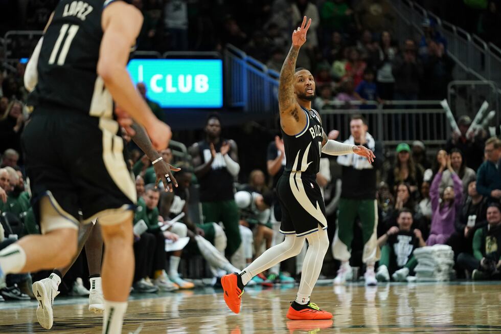 Milwaukee Bucks' Damian Lillard, center, gestures during the second half of an NBA basketball...