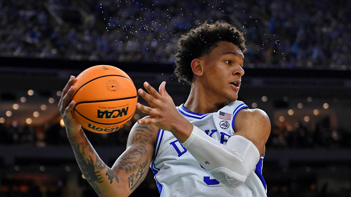 Sweat flies through the air as Duke Blue Devils forward Paolo Banchero (5) saves a ball from going out of bounds against the North Carolina Tar Heels during the second half during the 2022 NCAA men's basketball tournament Final Four semifinals at Caesars Superdome.
