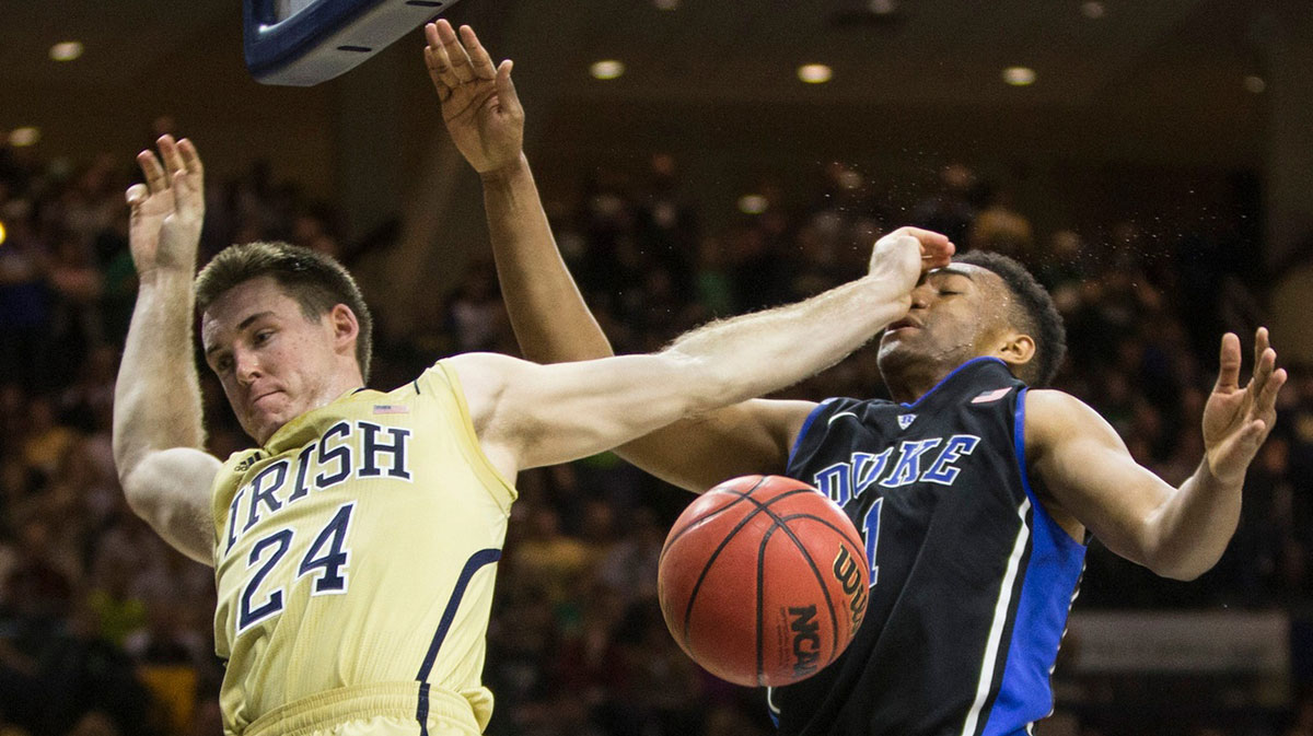 Notre Dame's Pat Connaughton (24) comes dunk from a late-game dunk next to Duke's Jabari Parker (1) during the mens basketball game between Notre Dame and Duke on Saturday, Jan. 4, 2014, inside the Purcell Pavilion at Notre Dame.