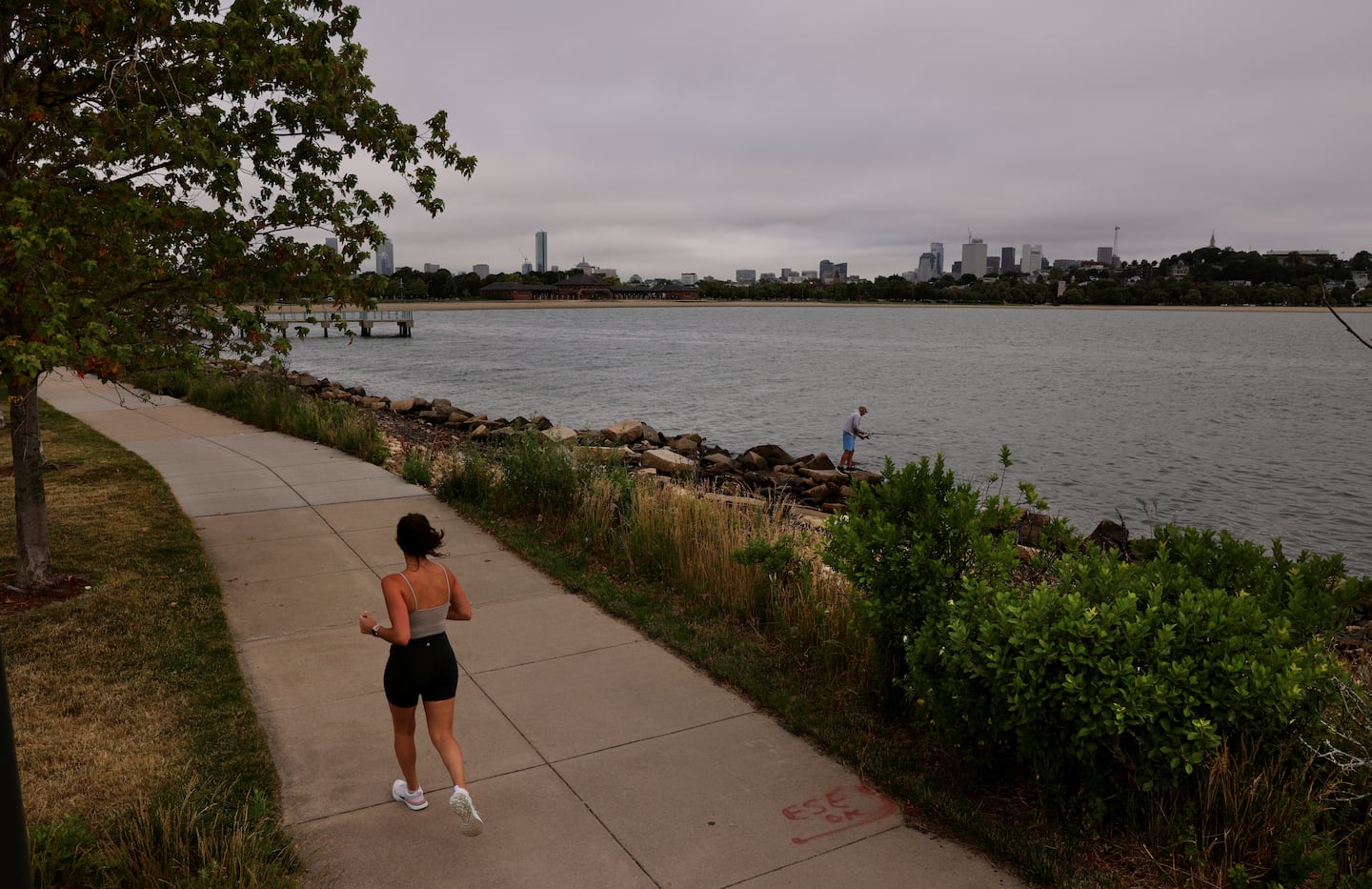 A woman jogged on the Harborwalk that runs along the former Bayside Expo Center property in Boston.
