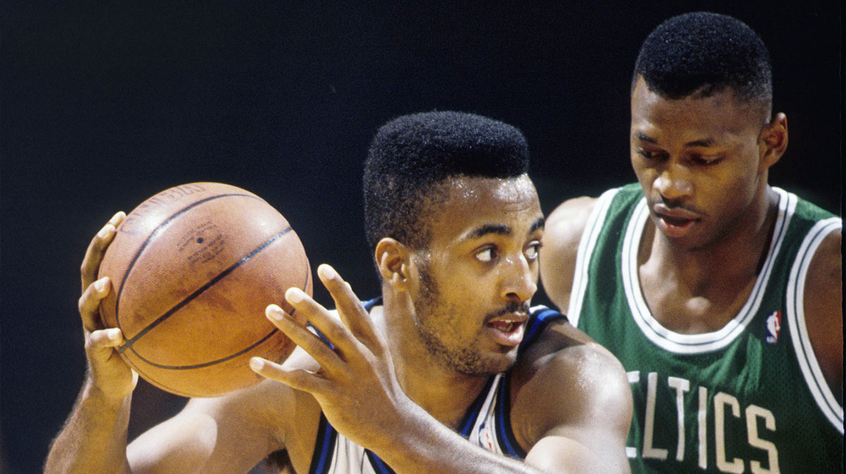 Orlando Magic guard Dennis Scott is defended by Boston Celtics guard Reggie Lewis (35) at the Orlando Arena.