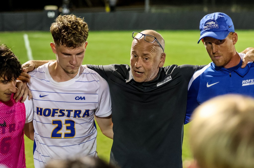 Hofstra soccer coach Richard Nuttall huddles up with his players.