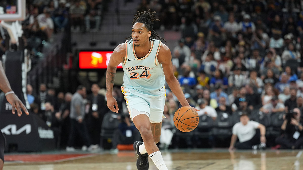 San Antonio Spurs guard Devin Vassell (24) dribbles up the court in the second half against the Golden State Warriors at Frost Bank Center.