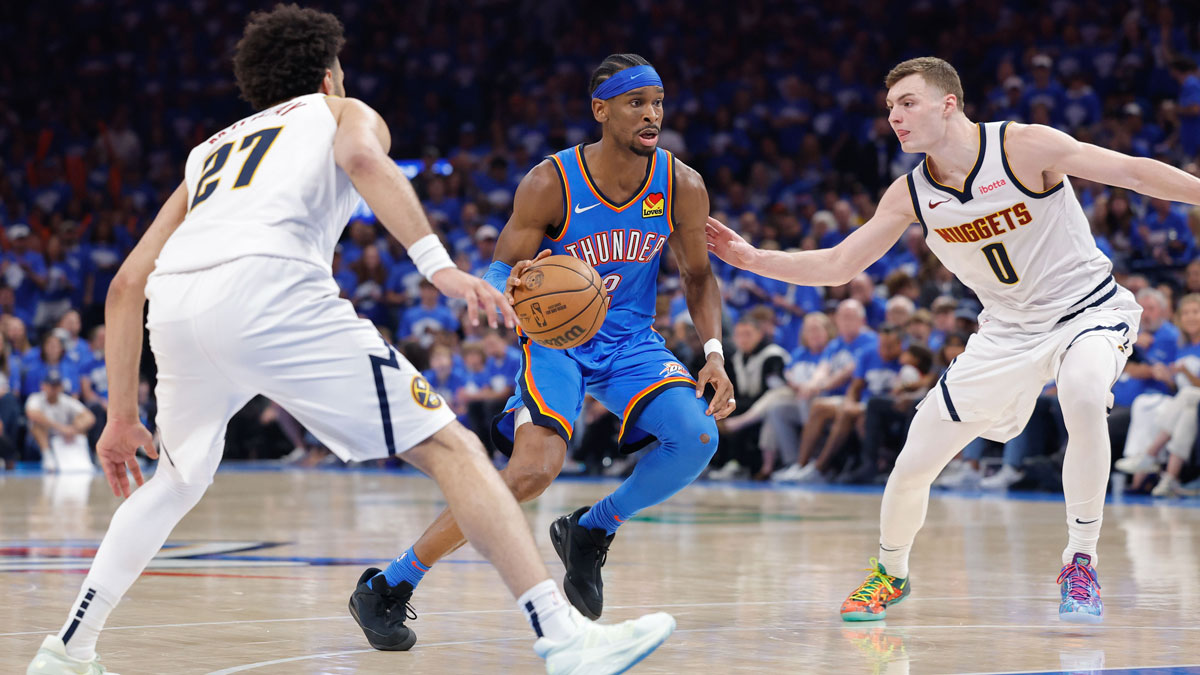 Oklahoma City Thunder guard Shai Gilgeous-Alexander (2) drives between guard Jamal Murray (27) and Denver Nuggets guard Christian Braun (0) in the second half during game seven of the second round for the 2025 NBA Playoffs at Paycom Center.