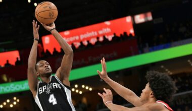 San Antonio Spurs guard De'Aaron Fox (4) shoots against Memphis Grizzlies forward Jaylen Wells in the first half of an NBA basketball game Saturday, March 1, 2025, in Memphis, Tenn. (AP Photo/Brandon Dill)