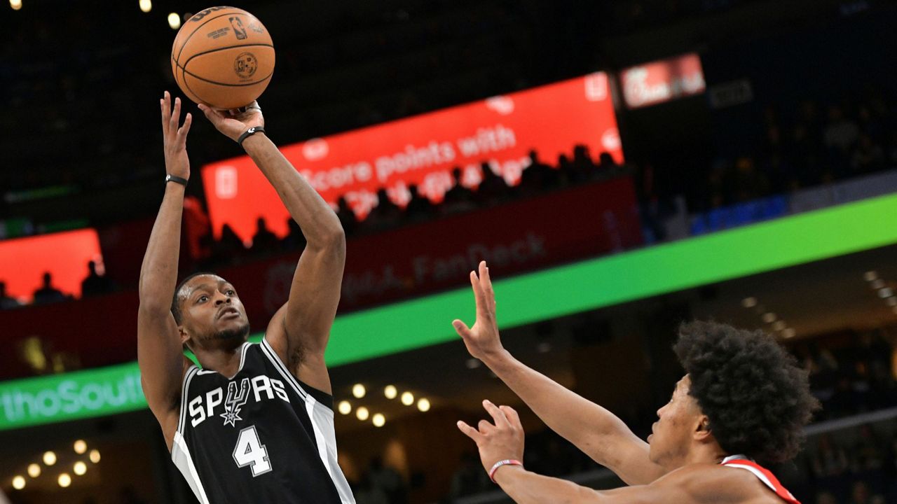 San Antonio Spurs guard De'Aaron Fox (4) shoots against Memphis Grizzlies forward Jaylen Wells in the first half of an NBA basketball game Saturday, March 1, 2025, in Memphis, Tenn. (AP Photo/Brandon Dill)
