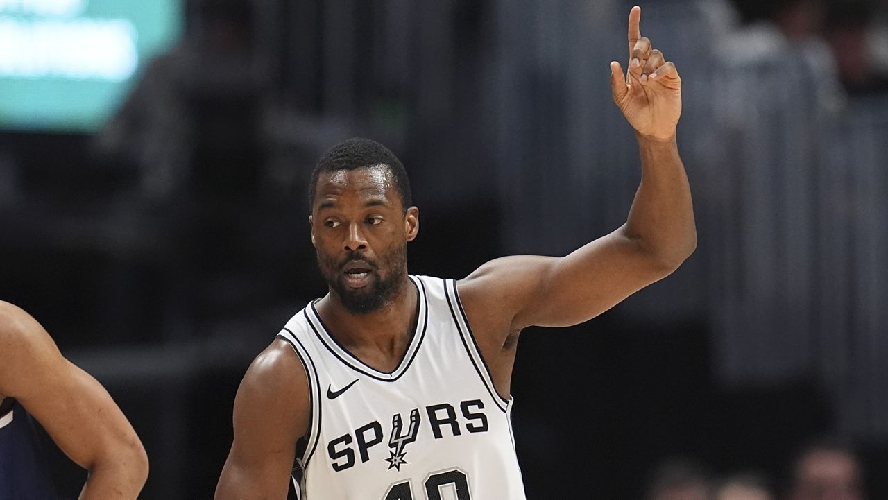 San Antonio Spurs forward Harrison Barnes gestures after hitting a 3-point shot against the Denver Nuggets in the first half of an NBA basketball game Wednesday, April 2, 2025, in Denver. (AP Photo/David Zalubowski)