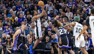 San Antonio Spurs guard De'Aaron Fox, center, goes up for a shot during the first half of an NBA basketball game against the Sacramento Kings, Friday, March 7, 2025, in Sacramento, Calif. (AP Photo/Sara Nevis)