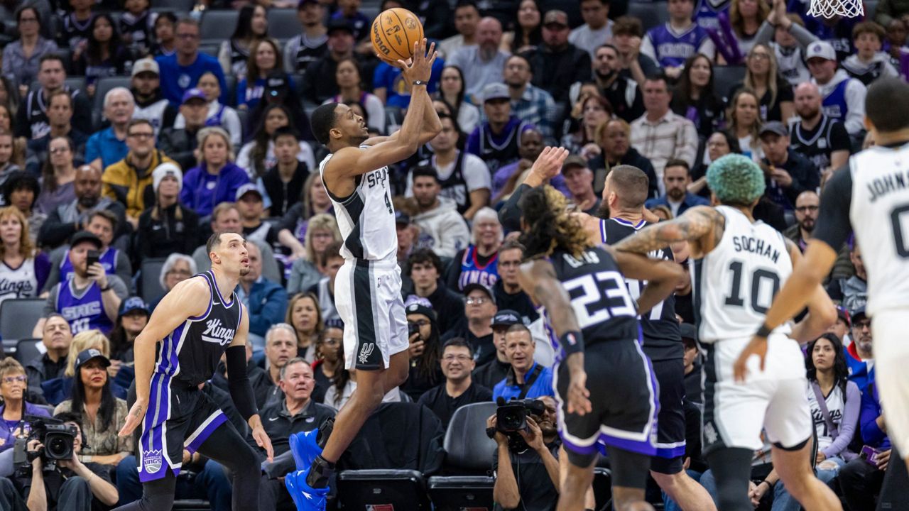 San Antonio Spurs guard De'Aaron Fox, center, goes up for a shot during the first half of an NBA basketball game against the Sacramento Kings, Friday, March 7, 2025, in Sacramento, Calif. (AP Photo/Sara Nevis)