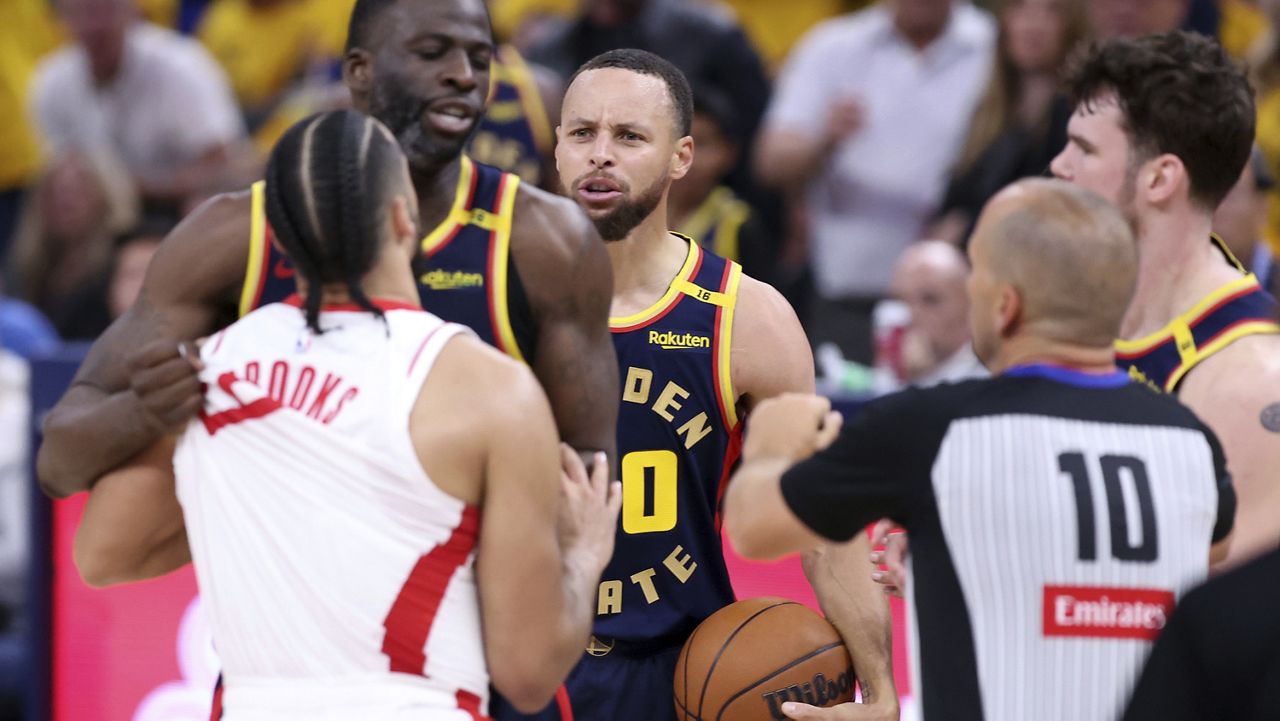 Golden State Warriors' Stephen Curry, center, watches Draymond Green scuffle with Houston Rockets' Dillon Brooks in the second quarter of an NBA Playoffs' First Round Game 4 at Chase Center in San Francisco on Monday, April 28, 2025.(Scott Strazzante/San Francisco Chronicle via AP)