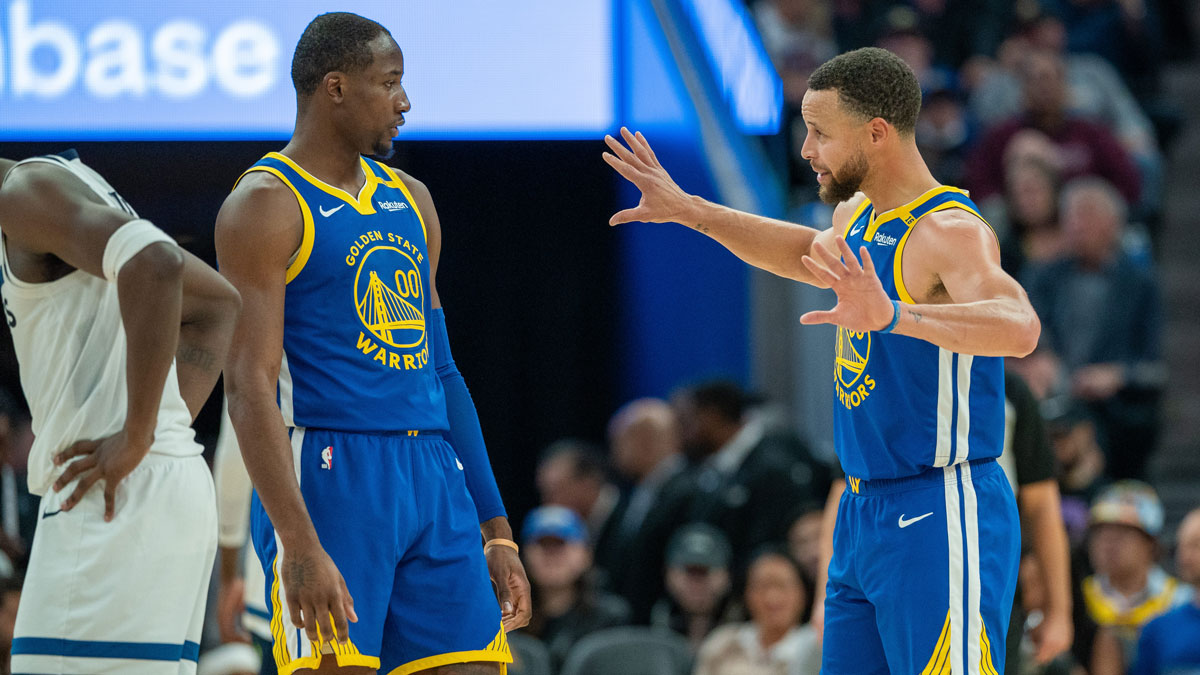 Golden State Warriors guard Stephen Curry (30) speaks with forward Jonathan Kuminga (00) during a time out against the Minnesota Timberwolves during the fourth quarter at Chase Center.