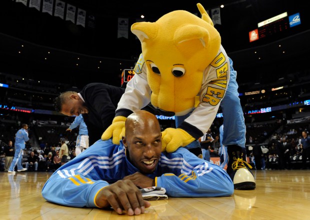 Denver Nuggets mascot Rocky helped get Chauncey Billups get limbered up before the game. The Denver Nuggets hosted the Los Angeles Clippers at the Pepsi Center, Dec. 3, 2010. (Karl Gehring/The Denver Post)