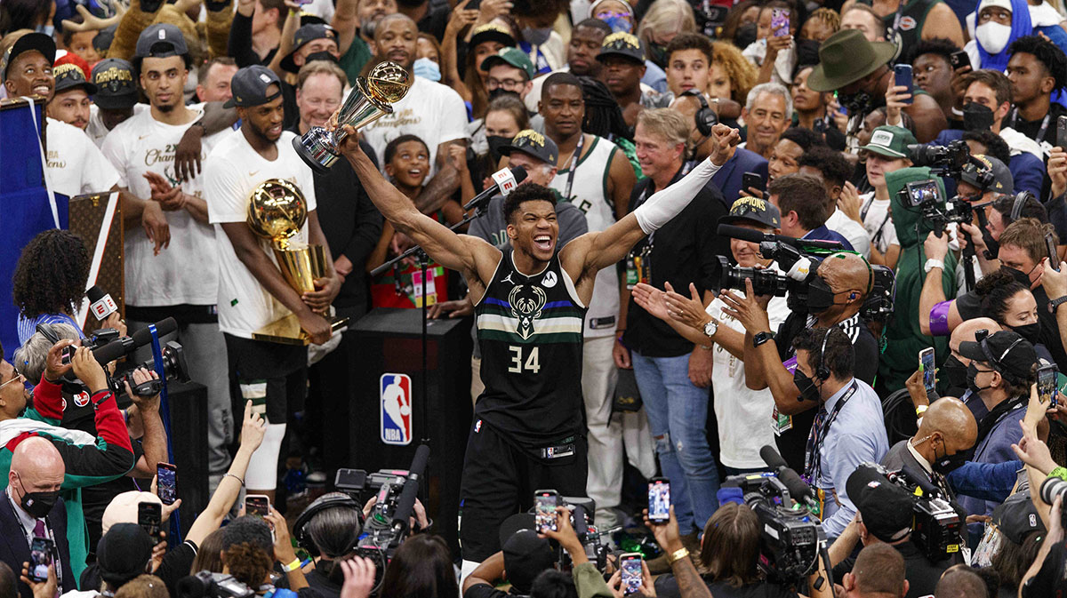 Milwaukee Bucks forward Giannis Antetokounmpo (34) celebrates with the NBA Finals MVP Trophy following the game against the Phoenix Suns following game six of the 2021 NBA Finals at Fiserv Forum.