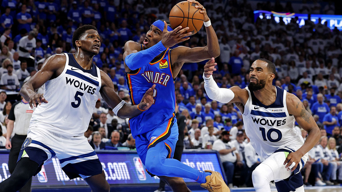 Thunder guard Shai Gilgeous-Alexander (2) drives to the basket against Minnesota Timberwolves guard Anthony Edwards (5) and guard Mike Conley (10) during the fourth quarter in game five of the western conference finals for the 2025 NBA Playoffs at Paycom Center
