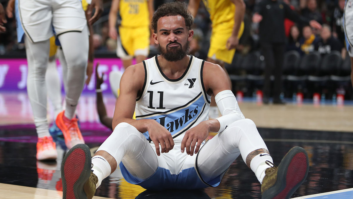 Atlanta Hawks guard Trae Young (11) sits on the court after being fouled by Indiana Pacers forward Pascal Siakam (43) during the first quarter at State Farm Arena.