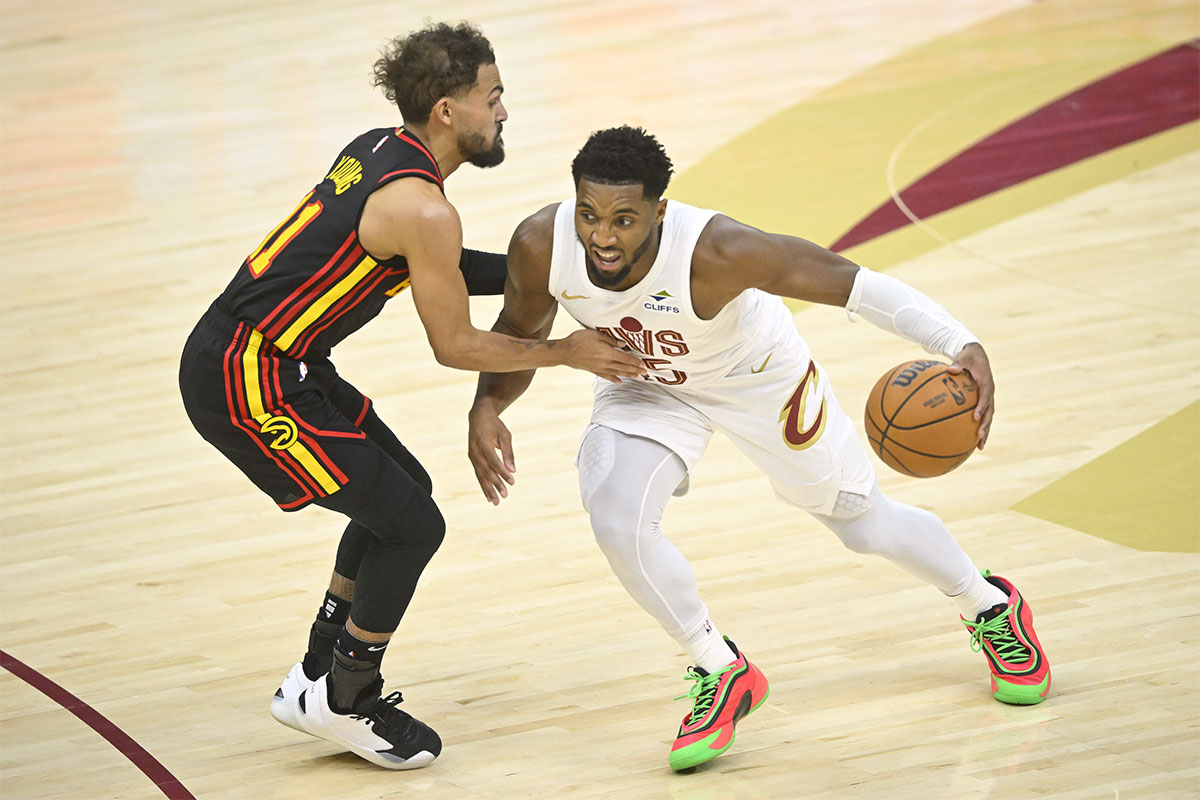 Cleveland Cavaliers guard Donovan Mitchell (45) brings the ball up court beside Atlanta Hawks guard Trae Young (11) in the fourth quarter at Rocket Mortgage FieldHouse.