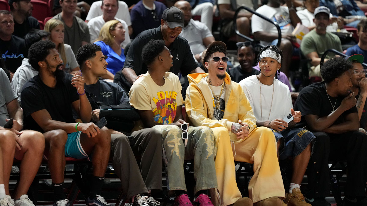 Jul 12, 2025; Las Vegas, NV, USA; Charlotte Hornets players Spencer Dinwiddie, Josh Okogie, Josh Green, Brandon Miller, LaMelo Ball and Tre Mann sit courtside for the Charlotte Hornets and Philadelphia 76ers game at Thomas & Mack Center. Mandatory Credit: Candice Ward-Imagn Images