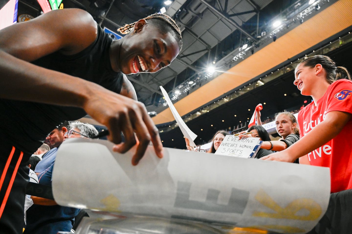 Sun guard Saniya Rivers signs autographs before Connecticut's game at TD Garden in July.