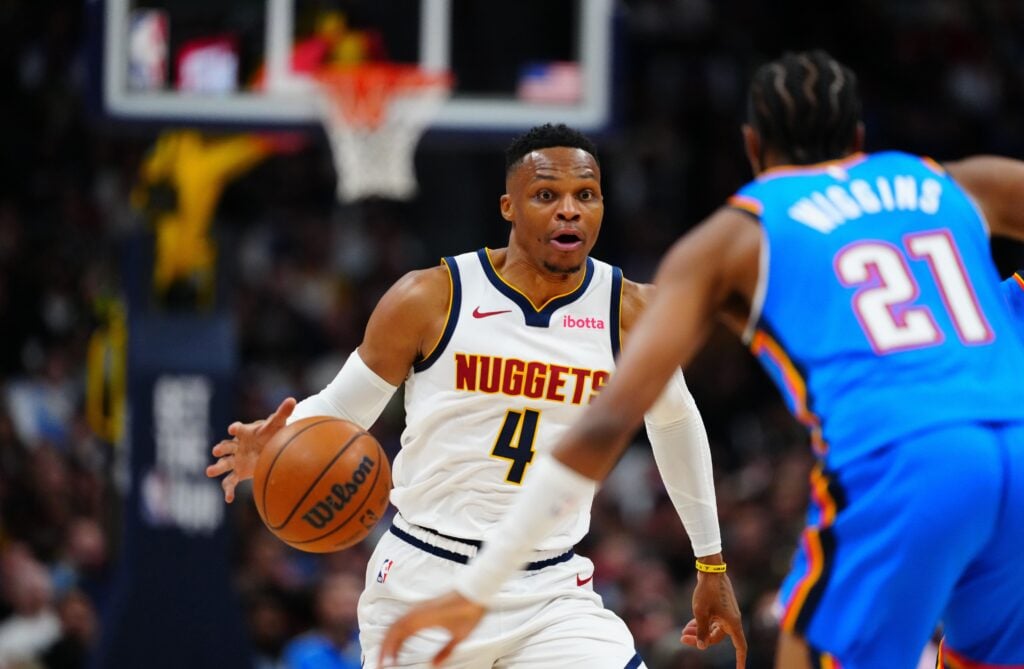 Oct 24, 2024; Denver, Colorado, USA; Denver Nuggets guard Russell Westbrook (4) drives at Oklahoma City Thunder guard Aaron Wiggins (21) in the second half at Ball Arena. Mandatory Credit: Ron Chenoy-Imagn Images