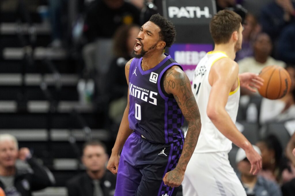 Dec 8, 2024; Sacramento, California, USA; Sacramento Kings guard Malik Monk (0) reacts after scoring against the Utah Jazz during the third quarter at Golden 1 Center. Mandatory Credit: Darren Yamashita-Imagn Images