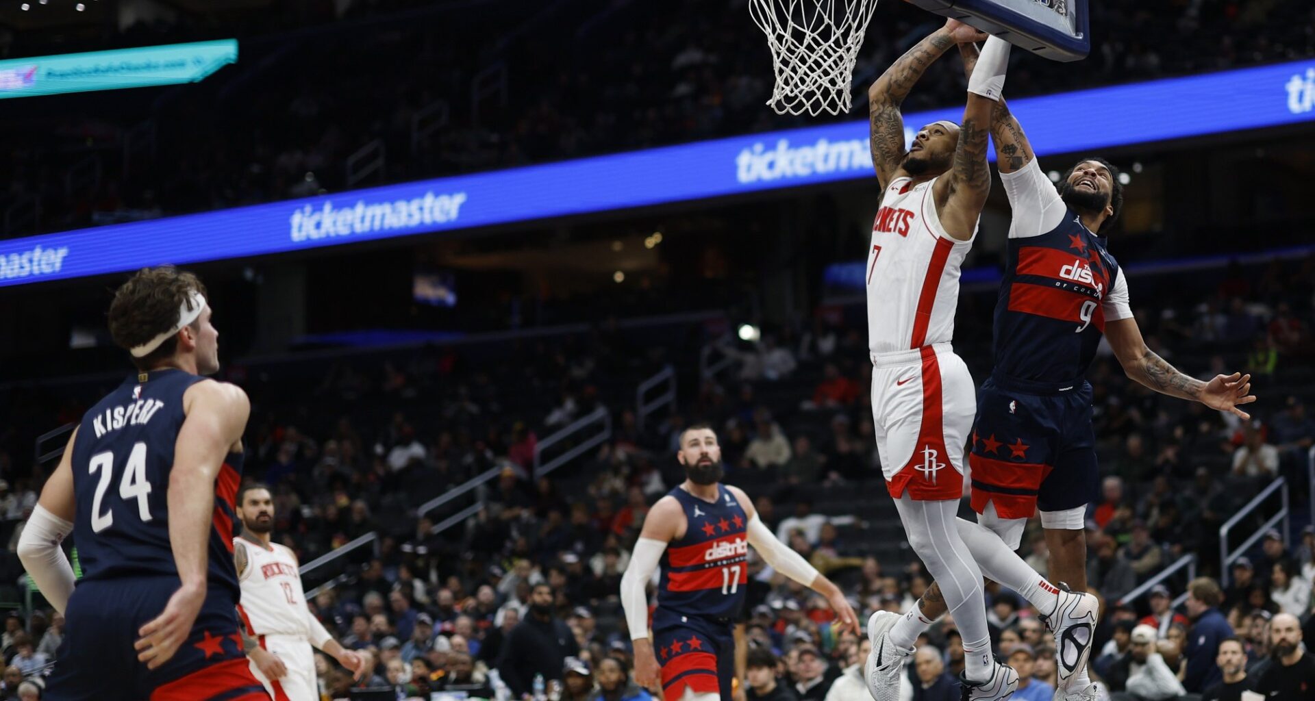 Jan 7, 2025; Washington, District of Columbia, USA; Houston Rockets forward Cam Whitmore (7) attempts to dunk the ball as Washington Wizards forward Justin Champagnie (9) defender ds in the fourth quarter at Capital One Arena. Mandatory Credit: Geoff Burke-Imagn Images