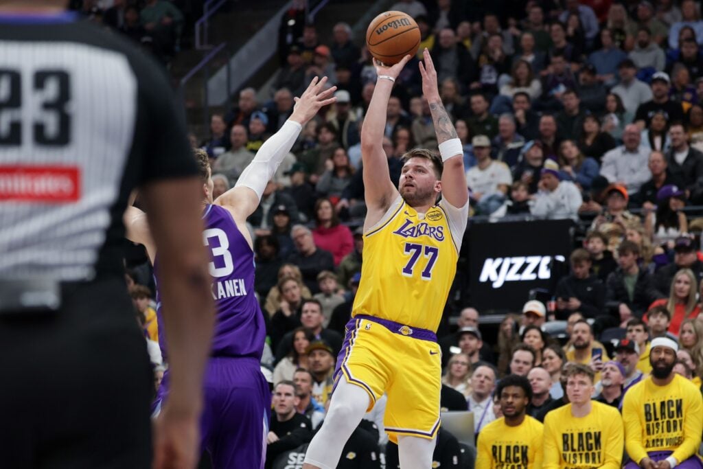 Feb 12, 2025; Salt Lake City, Utah, USA; Los Angeles Lakers guard Luka Doncic (77) shoots over Utah Jazz forward Lauri Markkanen (23) during the second quarter at Delta Center. Mandatory Credit: Chris Nicoll-Imagn Images