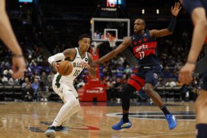 Milwaukee Bucks forward Kyle Kuzma (18) drives to the basket as Washington Wizards forward Khris Middleton (32) defends in the first half at Capital One Arena.