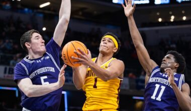 Mar 12, 2025; Indianapolis, IN, USA; Minnesota Golden Gophers guard Isaac Asuma (1) shoots the ball while Northwestern Wildcats center Keenan Fitzmorris (5) and guard Jordan Clayton (11) defend in the second half at Gainbridge Fieldhouse. Mandatory Credit: Trevor Ruszkowski-Imagn Images