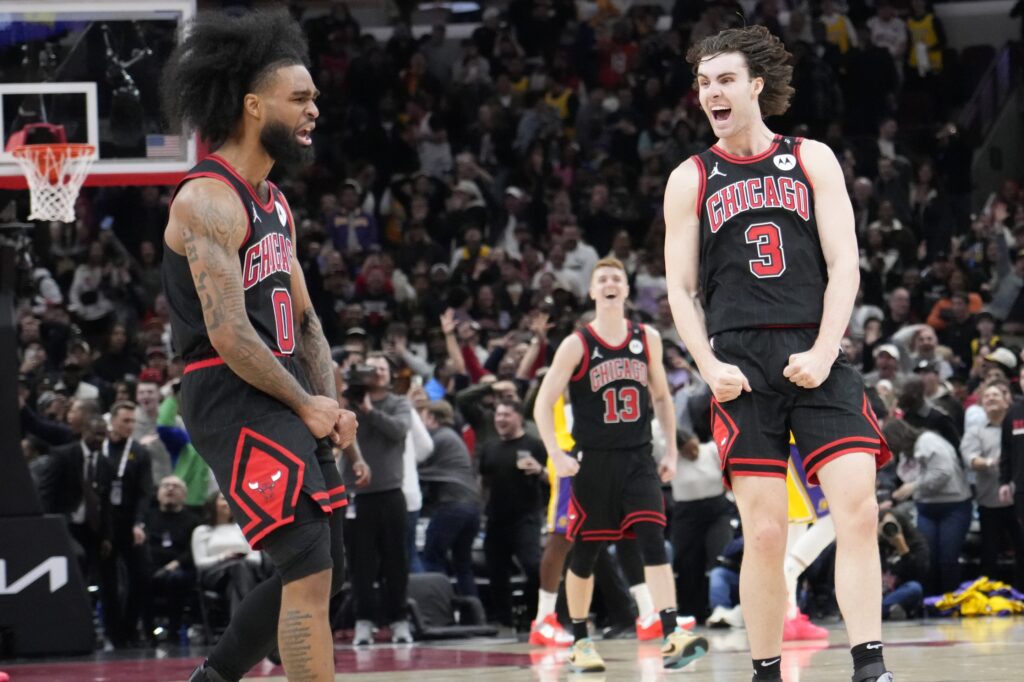 Mar 27, 2025; Chicago, Illinois, USA; Chicago Bulls guard Coby White (0) celebrates his three point basket against the Los Angeles Lakers with guard Josh Giddey (3) during the second half at United Center. Mandatory Credit: David Banks-Imagn Images